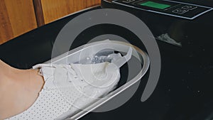 Automatic Thermal Shrinkable Shoe Cover Laminating Machine. Close up. Machine automatically applies shoe covers to the