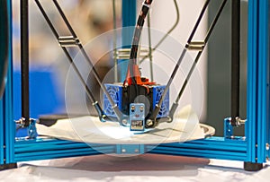 Automatic three-dimensional 3d printer performs product creation. 3d printing and automatic robotic technology, close-up