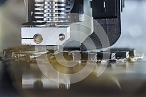 Automatic 3D printer machine printing black flat plastic model: close up