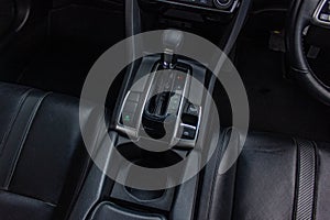 Automatic transmission shift selector in the car interior. Closeup a manual shift of modern car gear shifter.