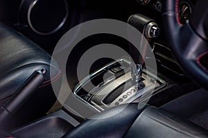 Automatic transmission shift selector in the car interior. Closeup a manual shift of modern car gear shifter.
