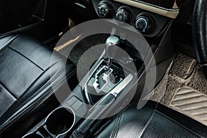 Automatic transmission shift selector in the car interior. Closeup a manual shift of modern car gear shifter.