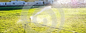 automatic water lawn working under green football field