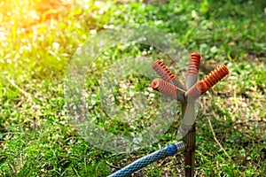 Automatic water sprinkler for lawn in the garden on a bright sunny day. Sprinkler is in static. photo on the background of