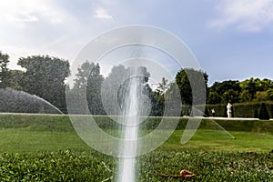 Automatic watering equipment, lawn maintenance, gardening and tools concept. Water jets automatically sprayed from a small