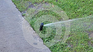 automatic watering grass, garden lawn sprinkler in action.
