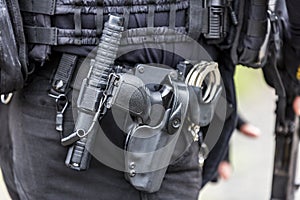 Automatic weapon, pistol in the hands of a well-equipped and trained military policeman or special forces person.