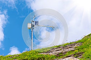 Automatic weather station, with a weather monitoring system at the top of the mountain range photo