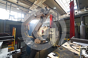 Automatic welding robot mechanical arm is working in the modern automobile parts factory.