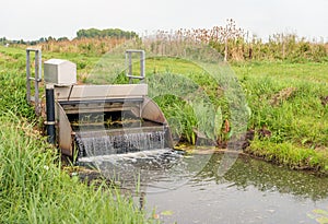 Automatic working small weir controls the water in a Dutch polder
