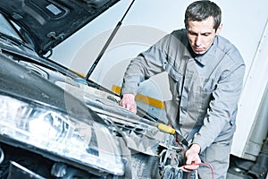 Automobile car electrician at work