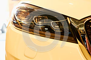 Automobile headlights of new modern car. yellow warm tones