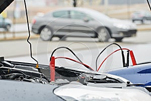Automobile help. booster jumper cables charging automobile discharged battery