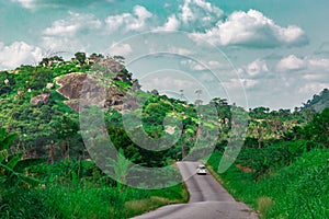 Automobile on a longer section of a disappearing rural road Ekiti State Nigeria. Disappearing road 