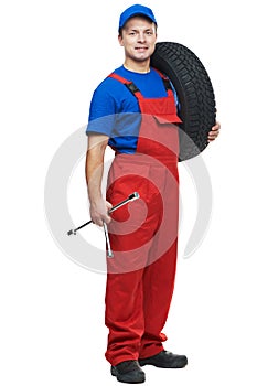 Automobile mechanic with car tire and spanner photo