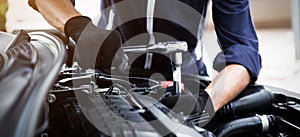 Automobile mechanic repairman hands repairing a car engine automotive workshop with a wrench, car service and maintenance , Repair