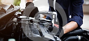 Automobile mechanic repairman hands repairing a car engine automotive workshop with a wrench, car service and maintenance , Repair