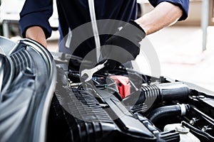 Automobile mechanic repairman hands repairing a car engine automotive workshop with a wrench, car service and maintenance , Repair
