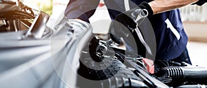 Automobile mechanic repairman hands repairing a car engine automotive workshop with a wrench, car service and maintenance , Repair