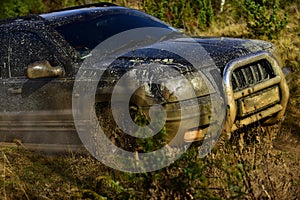 Automobile racing, car wash and off road vehicle concept. SUV takes part in racing on fall nature background Car with