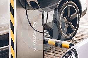 Automobile refueling for electric cars e-mobility in the background car, wheel.