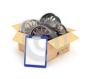 Automobile rims in an open cardboard