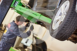 Automobile service in garage workshop. Tyre replacement