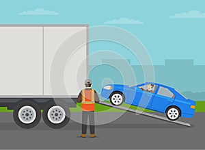 Automobile shipping service. Blue sedan car entering semi-trailer. Shipping truck being loaded by cars.