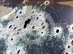 Automobile shot up bullet gun fire holes windshield