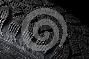 Automobile tire on black background