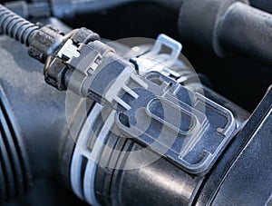 Automotive air flow sensor, close-up. Measures the amount of air entering the engine and sends it to the electronic