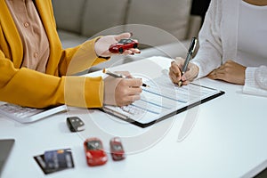 Automotive Business, Car Sale or Lease Concept: Car Dealership and sign contracts in car showrooms or car dealership office