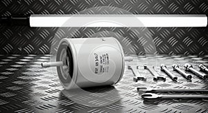 Automotive Filter and Wrenches on Metal Surface in Black and White