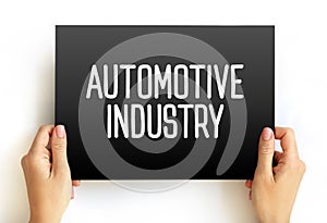 Automotive industry - companies and activities involved in the manufacture of motor vehicles, text concept on card