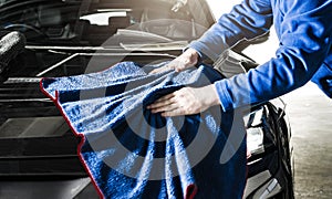 Car Detailer Cleaning Vehicle Body Using Soft Cloth photo