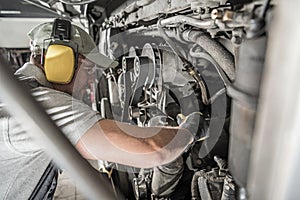 Automotive Mechanic Looking Inside Engine Compartment