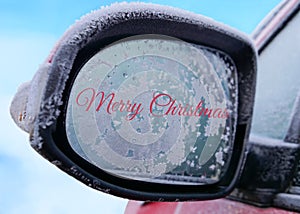 Automotive Merry Christmas text on frosty car mirror