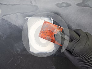 Hand-held car putty.Car paintwork repair technology photo