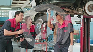 Automotive supervisors' teams inspect repair work at a car garage.