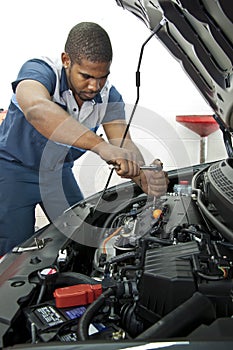 Automotive Technician Works On Car Engine