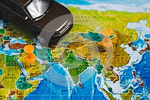 Automotive Travel Destination Points on World Map Indicated with Colorful Thumbtacks and Shallow Depth of Field.