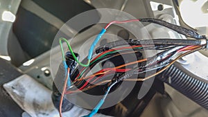 automotive wiring harness with traces of repair and new damage to the wires