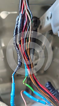 automotive wiring harness with traces of repair and new damage to the wires