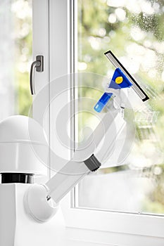 A autonomous robot is washing a window