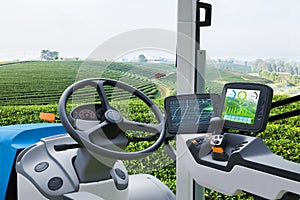 Autonomous tractor working in green tea field, Future technology with smart agriculture farming concept