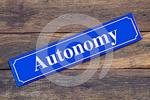 Autonomy street sign on wooden background