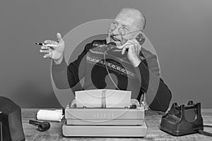 Autor from the past. Desk with telephone and typewriter. Vintage. Writer editor. black and white photo