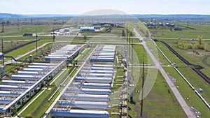 Autos drive and gas tanks on foreground upper view