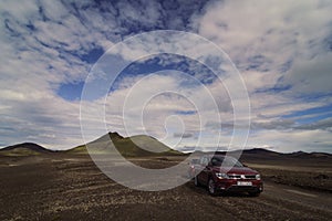 Autos driving across desert valley landscape photo