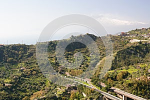 A18 motorway Messina - Catania and view of snowy Etna volcano. Taormina. Sicily. Italy photo